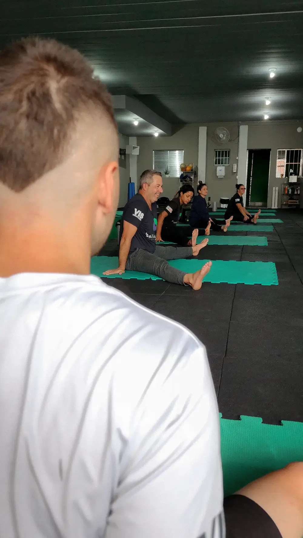Turma alongando com o professor observando